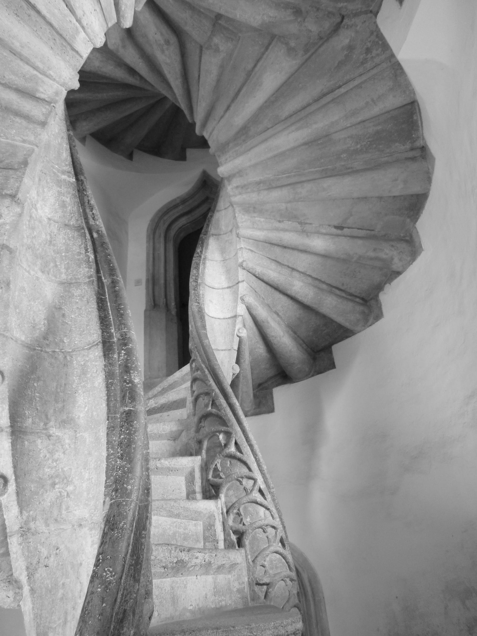 A stone staircase with narrow, carved railings.