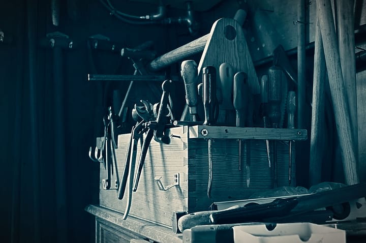 A black and white photo of a wooden tool box.